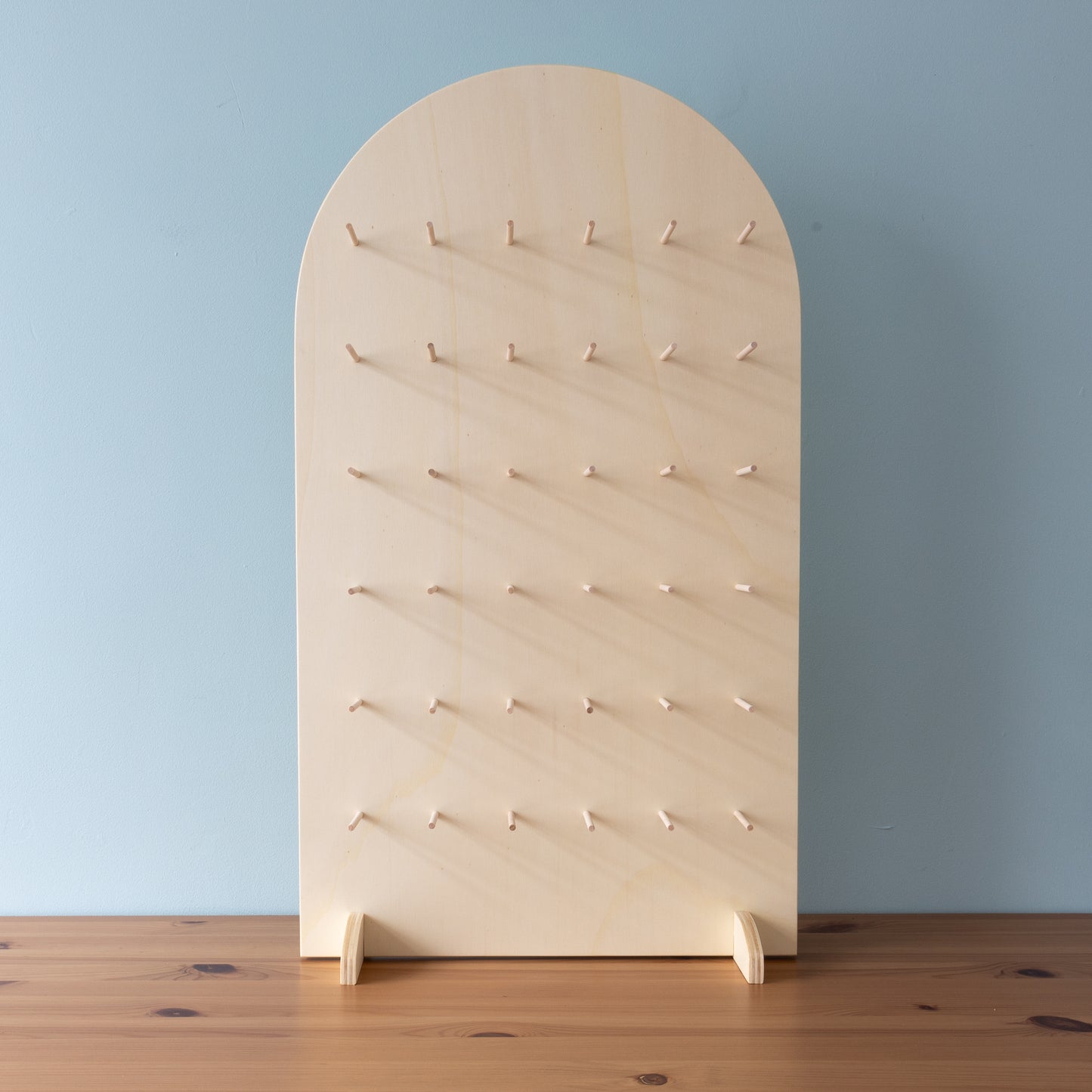 curved top pegboard stand